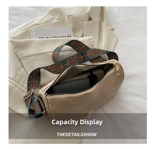Detail of beige baguette bag interior showing capacity with a colorful patterned strap