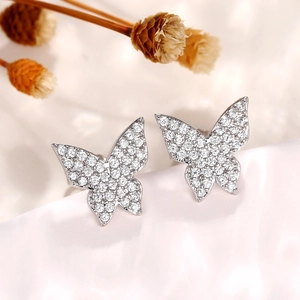 Macro shot of silver butterfly stud earrings with sparkling pavé micro-set cubic zirconia