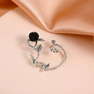 Detailed view of silver thorn vine ear cuff with a 3D black rose in gothic style