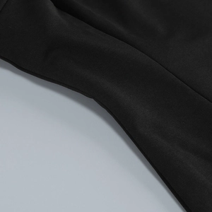Detail of flat seam stitching and texture on a black bodycon mesh evening dress