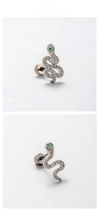 Macro view of silver snake stud earring with green zircon eyes and crystal pavé details