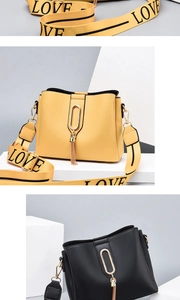 Detail of wide fabric strap with LOVE print and gold tassel on yellow bucket bag