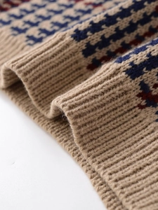 Macro shot of houndstooth knit texture and ribbed cuffs on a winter sweater
