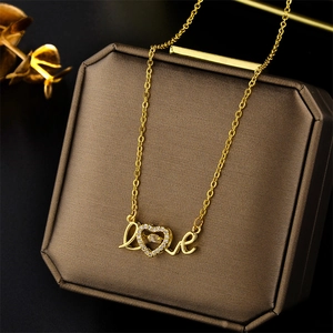 Golden titanium steel necklace with dancing stone love heart pendant on jewelry box