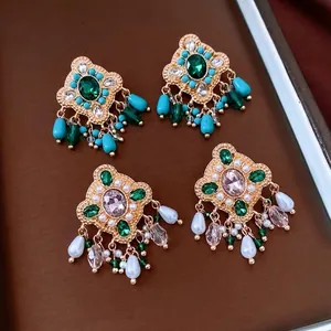 Vintage bohemian drop earrings with emerald and lavender stones in gold-tone setting