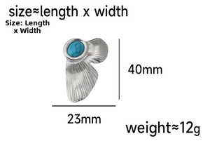 Detailed view of silver butterfly wing earrings with blue turquoise stone and 40mm measurements
