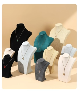 Detailed view of necklace display stands in velvet and linen materials for jewelry display