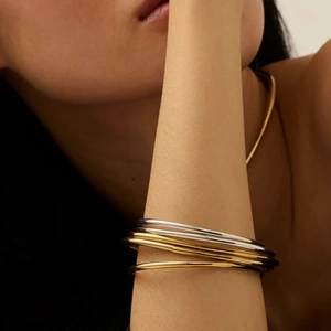 Minimalist multi-layered stainless steel bangle set in gold and silver finish