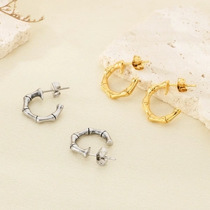 Detailed view of bamboo texture on C-shaped stainless steel earrings in gold and silver