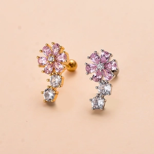Detailed shot of gold and silver flower stud earrings with pink zircon and screw ball backs
