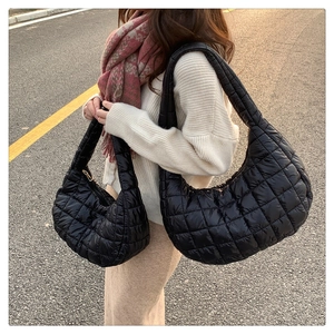 Quilted nylon shoulder bags in large and small sizes shown in a street fashion setting