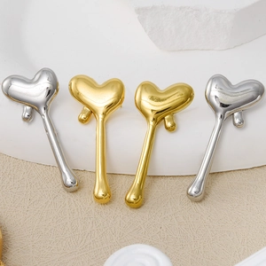 Macro detail of 304 stainless steel heart-shaped earrings with liquid metal texture finish