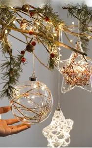 Luminous Christmas glass ball and star pendants with LED lights on pine branches