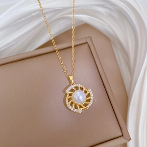 Detailed macro of golden necklace with rotating pearl and zircon stones on silk