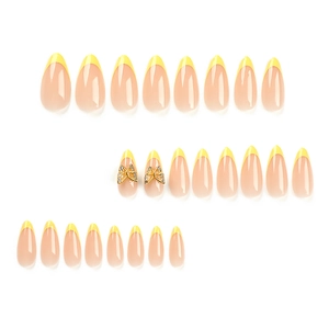 French almond press-on nails with yellow tips and 3D golden butterfly rhinestone decor