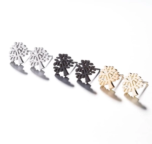 Detailed view of hollow-out tree of life stud earrings in silver, black, and gold colors