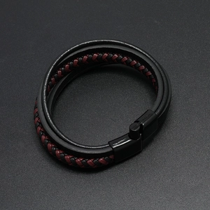 Close-up of black and red braided leather bracelet with black magnetic clasp