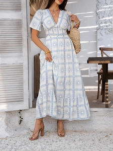 Detailed view of white V-neck dress with blue geometric sun print and elastic high waist