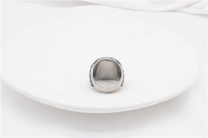 Detail of vintage wolf steel ring showing intricate Celtic engraving and polished band