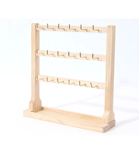 Detailed view of 3-tier wooden jewelry stand with metal hooks and base storage tray
