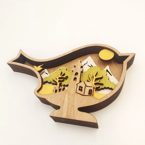 Detailed layered wood carving of a bird with mountain scenery and sun interior décor
