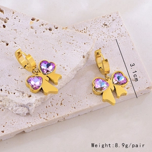 Detail of golden bow earrings with purple heart crystals showing size 3.1cm and weight 8.9g