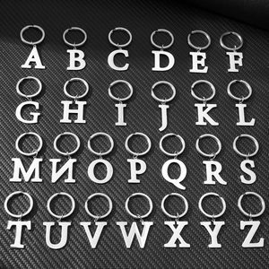 Complete A-Z set of 26 silver metal alphabet keychains neatly arranged on a black background