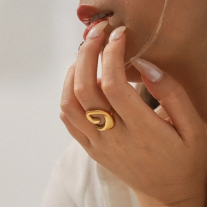 Close-up of 18K gold plated hollow threaded stainless steel ring on model hand