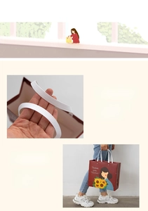 Detail of red gift paper bag for teachers with rivet handle and 'Thank you' text