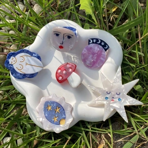 Artistic acetate hair clips in star, mushroom and abstract shapes on a cloud tray