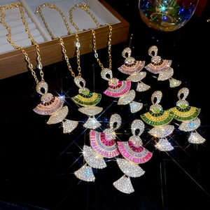 Detailed close-up of golden fan-shaped jewelry set with sparkling rhinestones and starburst effect