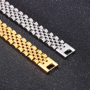 Punk style stainless steel watch band bracelet in gold and silver finish on dark background
