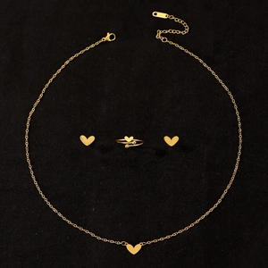 Golden stainless steel jewelry set featuring heart shaped necklace ring and earrings