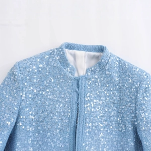 Blue sequined tweed jacket with stand collar, showcasing shoulder and neckline details