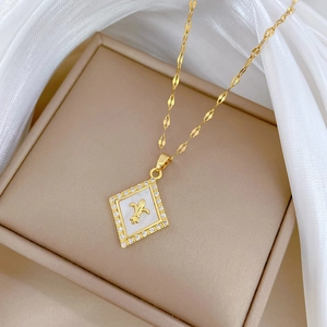 Golden titanium steel rhombus necklace with shell inlay and fleur-de-lis on silk