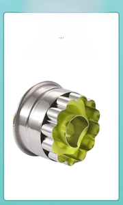 Detail view of scalloped stainless steel cookie cutter with green non-slip hand guard