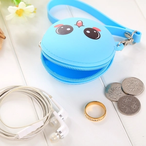 Close-up of blue silicone coin purse with cute cartoon face and wrist strap detail