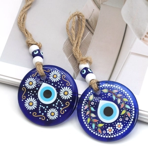 Handmade Evil Eye blue glass charms with daisy patterns and nautical rope tassels