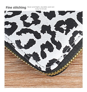 Close-up of leopard print card holder featuring cross-grain texture and durable stitching
