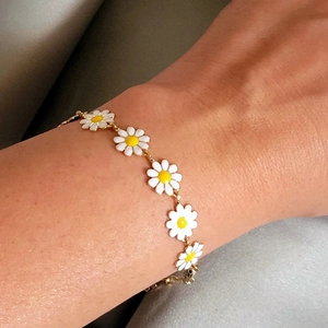 Bohemian gold daisy chain bracelet with white enamel flowers for women on wrist