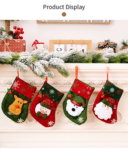 Detail of four Christmas stockings with reindeer and snowman hanging on a white fireplace