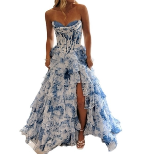 Detail of layered ruffle hem and high slit on a blue floral strapless evening gown