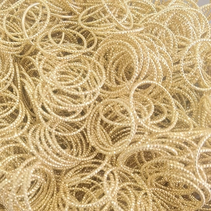 Detailed view of bulk golden twisted titanium steel jump rings for jewelry making