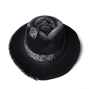 Top view of a black wool fedora with a skull relief and paisley pattern trim details