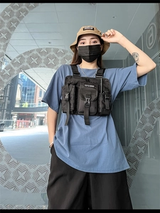 Detail of black nylon tactical vest bag featuring multi-pockets and adjustable buckles
