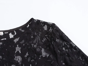 Close-up of the round neckline and delicate black lace texture with size S label