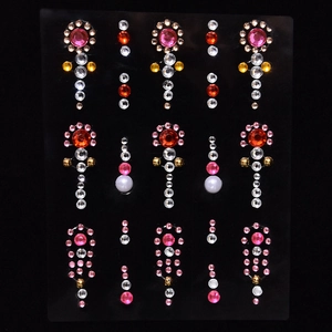 Detailed view of colorful gemstone stickers with pearl accents for makeup and body art