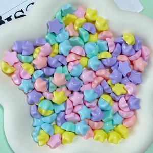 Macro shot of colorful star-shaped resin charms in macaron tones for DIY crafts