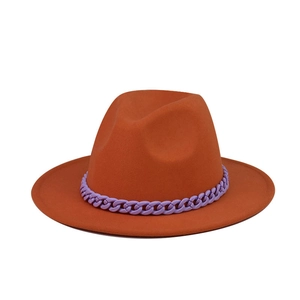 Detail of orange wide brim felt fedora hat featuring a purple chunky chain band