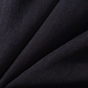 Macro shot of high-density black twill fabric texture showing premium weaving quality